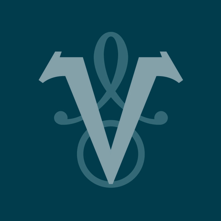 A stylized monogram logo featuring a large pale teal letter V with decorative flourishes behind it, centred on a dark teal background.